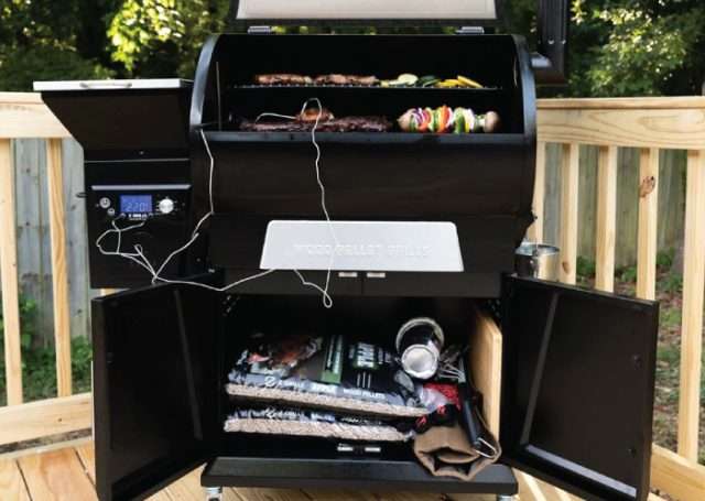 The Z Grills Flagship 700D4E cooking with storage cabinet open and full