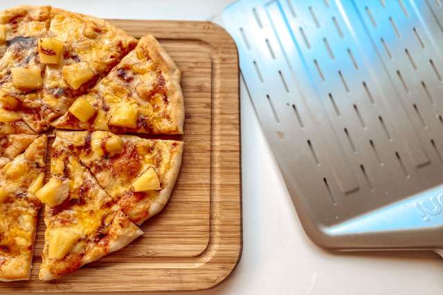 12 inch pizza cooked in the Ooni Volt 12 sliced and on a cutting board